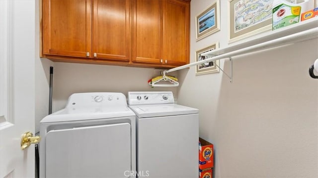 laundry room with cabinets and separate washer and dryer