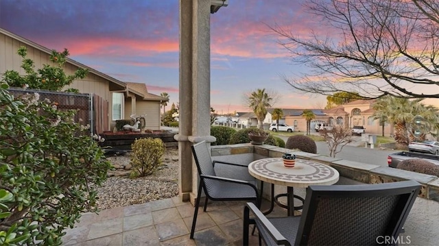 view of patio terrace at dusk