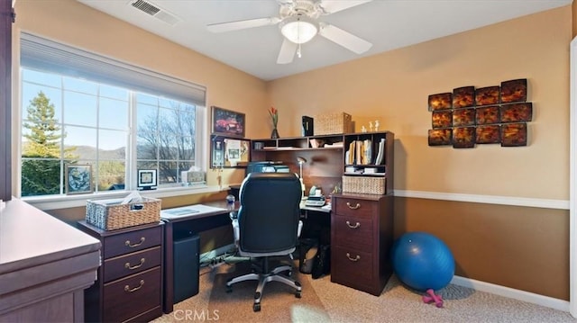 carpeted office featuring ceiling fan