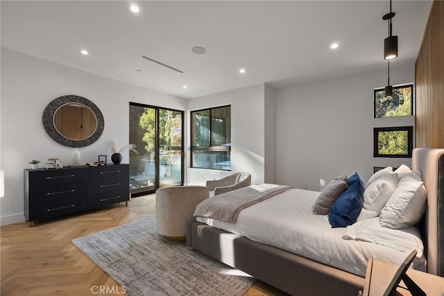 bedroom featuring light parquet flooring and access to outside