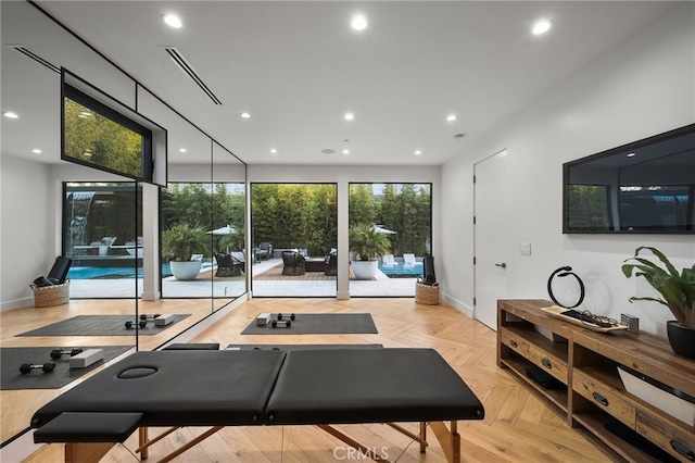 exercise area featuring light parquet floors