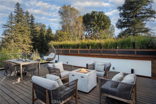 wooden deck with an outdoor living space with a fire pit