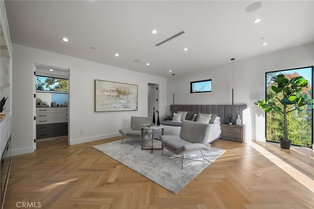 bedroom featuring multiple windows and light parquet floors