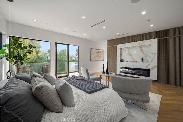 bedroom featuring parquet flooring and access to exterior