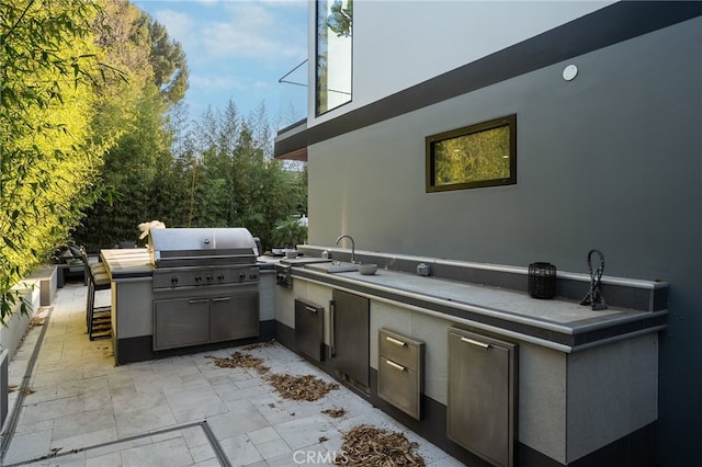 view of patio / terrace with a grill, area for grilling, and a wet bar