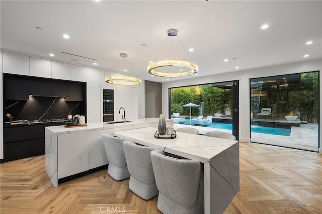 dining room with sink and light parquet floors