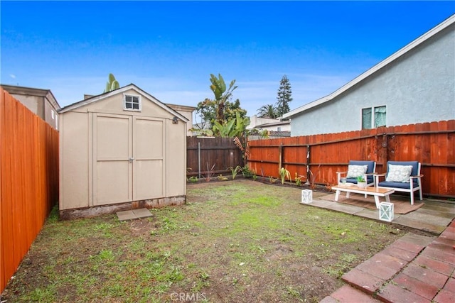 view of yard featuring a storage unit and a patio area