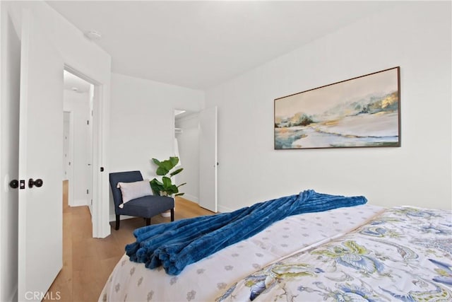 bedroom featuring a closet and light wood-type flooring