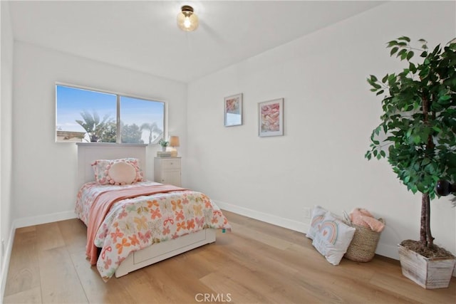 bedroom with hardwood / wood-style floors