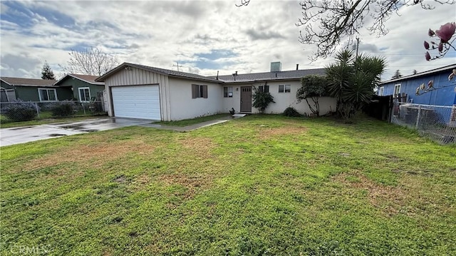 ranch-style home featuring a garage and a front lawn