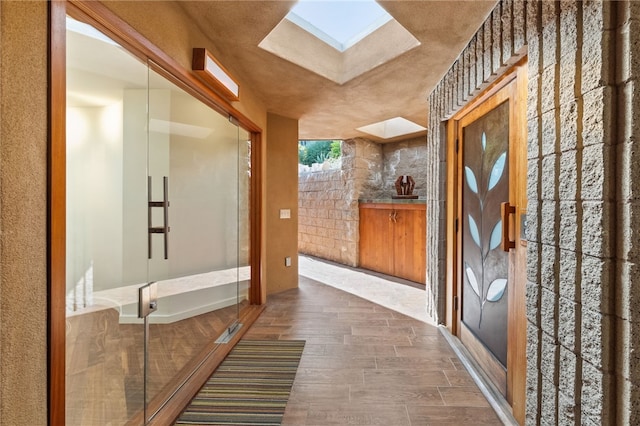 bathroom featuring a skylight and wood finished floors