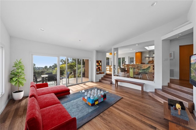 living room featuring recessed lighting, wood finished floors, visible vents, vaulted ceiling, and stairway