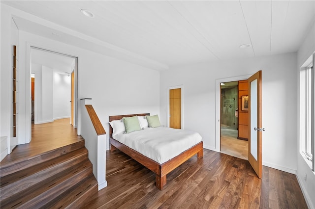 bedroom featuring dark wood-style floors and baseboards