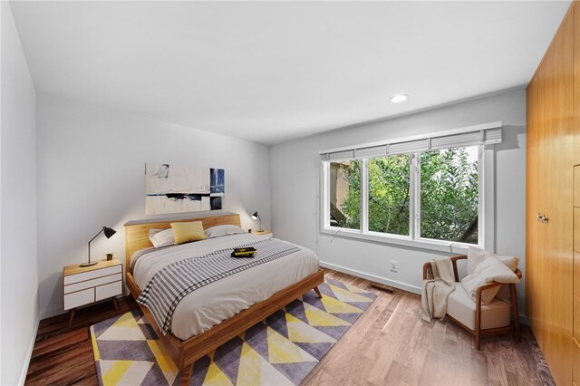 bedroom featuring recessed lighting, visible vents, baseboards, and wood finished floors