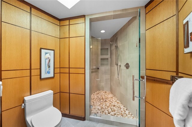 bathroom with a stall shower and toilet