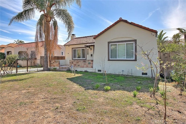 mediterranean / spanish-style house with a front yard