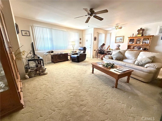 living room with ceiling fan and carpet flooring