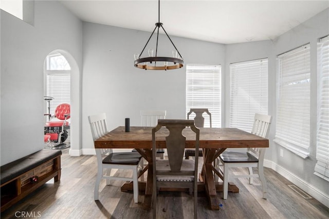 dining room with a notable chandelier and hardwood / wood-style flooring