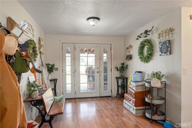 entryway featuring a textured ceiling and light hardwood / wood-style flooring