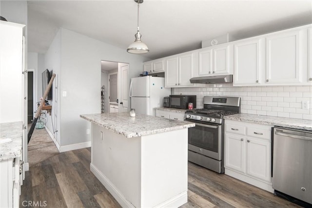 kitchen with white cabinetry, stainless steel appliances, a center island, and pendant lighting