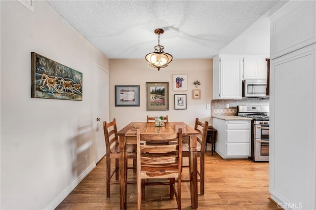 28010 Tiffany Ln Unit 309, Canyon Country, CA 91387 - dining area with light wood-type flooring and a textured ceiling