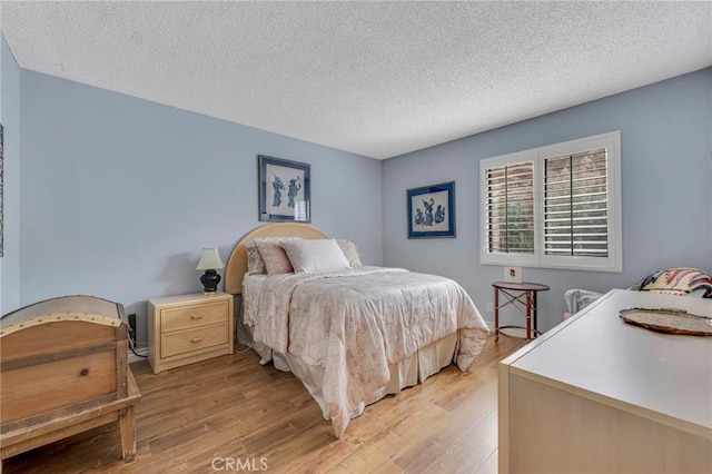 28010 Tiffany Ln Unit 309, Canyon Country, CA 91387 - bedroom featuring a textured ceiling and light wood-type flooring
