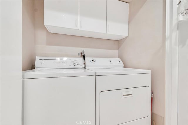 laundry room featuring cabinet space and separate washer and dryer