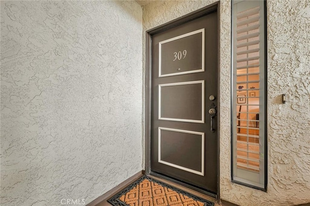 doorway to property with stucco siding