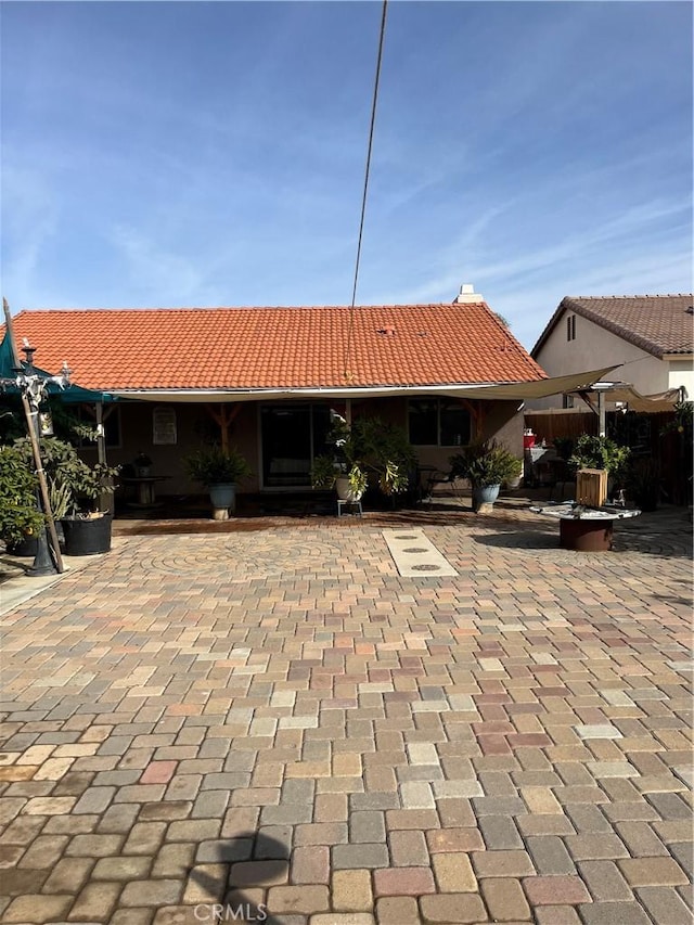 rear view of property featuring a patio area