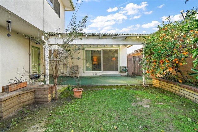 back of house with a pergola, a lawn, and a patio