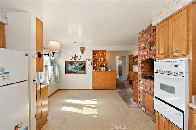 kitchen featuring hanging light fixtures, an inviting chandelier, light colored carpet, and white appliances