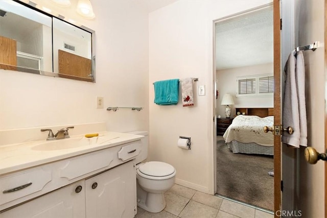 bathroom with tile patterned flooring, vanity, a shower with door, and toilet