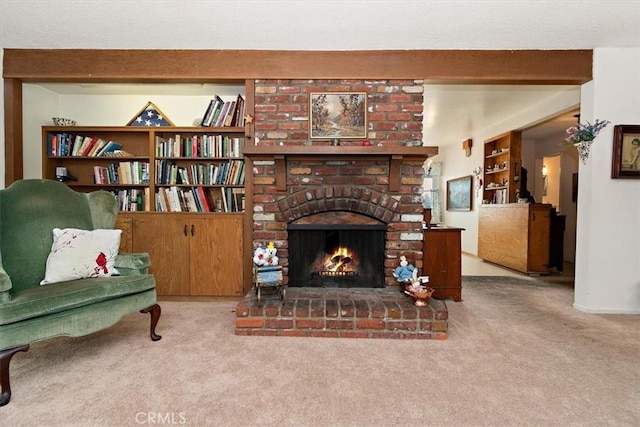 living area with a brick fireplace and light carpet