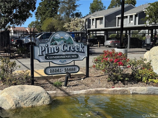 community sign featuring a water view