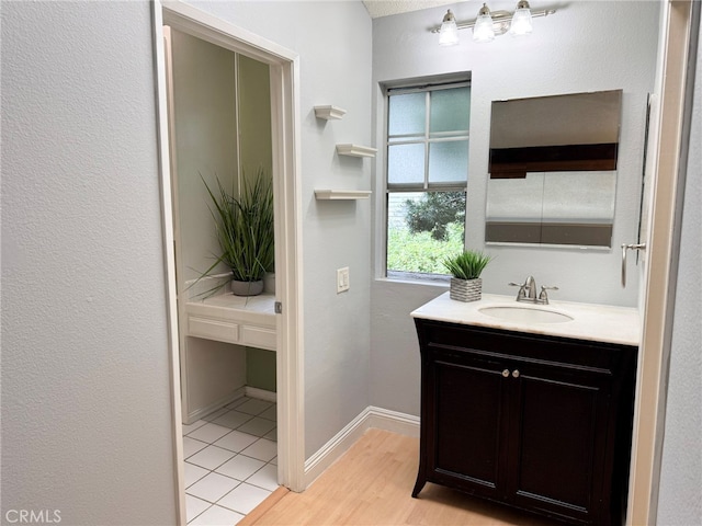 bathroom with vanity and hardwood / wood-style floors