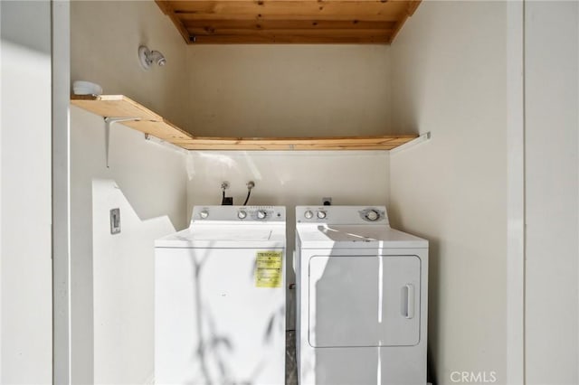 washroom featuring washing machine and clothes dryer and wooden ceiling