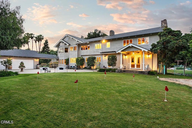 view of front of house with french doors, a chimney, a patio area, and fence