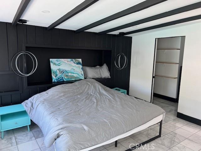 bedroom featuring beam ceiling