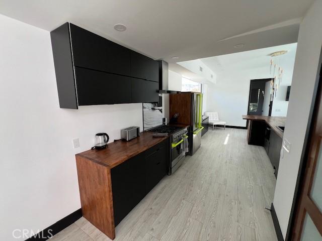 kitchen with gas range and light hardwood / wood-style floors