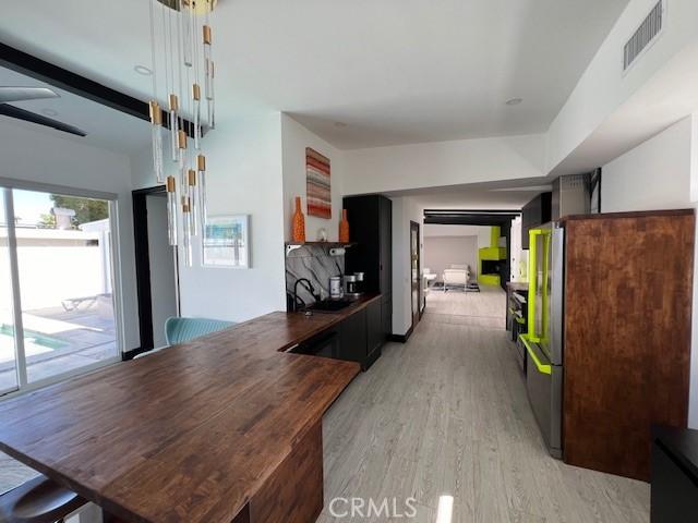 interior space with sink and light hardwood / wood-style floors