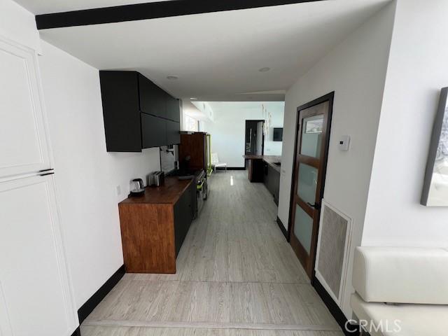 corridor featuring light hardwood / wood-style floors