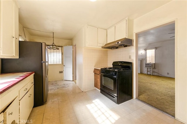 kitchen featuring white cabinetry, pendant lighting, stainless steel fridge, light carpet, and black range with gas cooktop