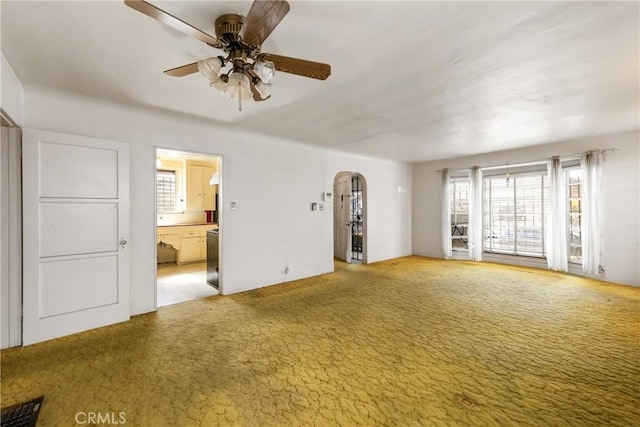 interior space with ceiling fan and light colored carpet