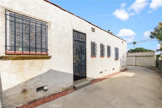 doorway to property featuring a patio area