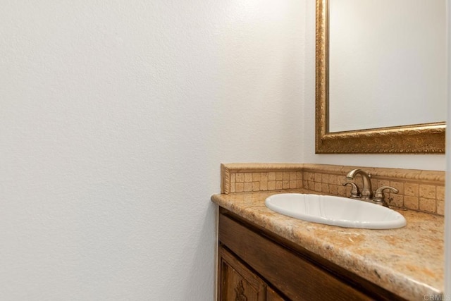 bathroom featuring tasteful backsplash and vanity