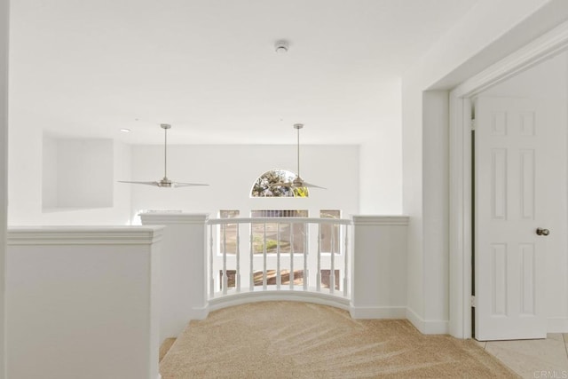hall with baseboards and carpet flooring