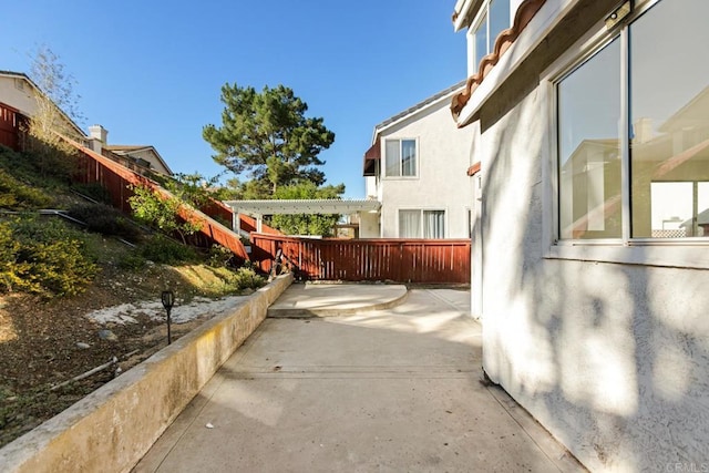view of side of property with a patio area and stucco siding