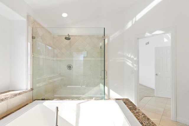 full bathroom featuring a stall shower, a tub to relax in, tile patterned flooring, and recessed lighting