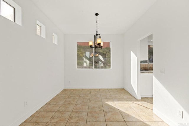 unfurnished dining area with a wealth of natural light, an inviting chandelier, and light tile patterned flooring