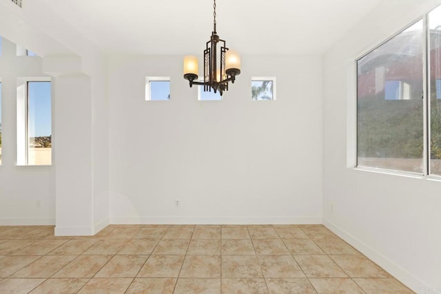 unfurnished dining area featuring tile patterned floors, an inviting chandelier, baseboards, and visible vents